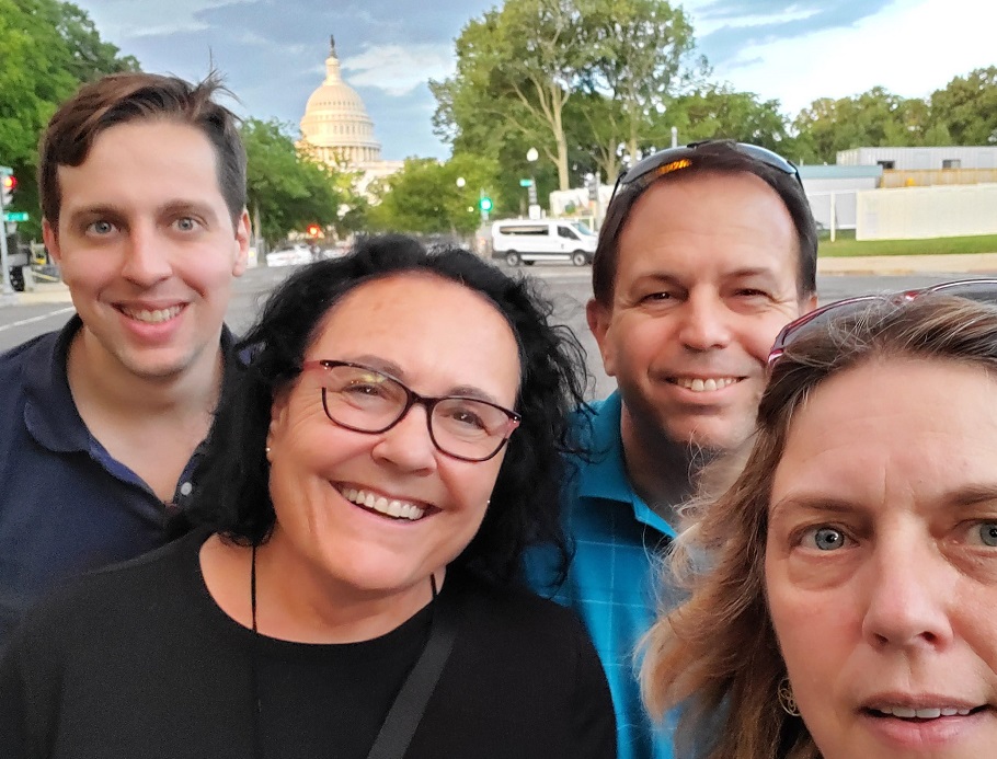 Four IECAM staff members taking a selfie on a city street