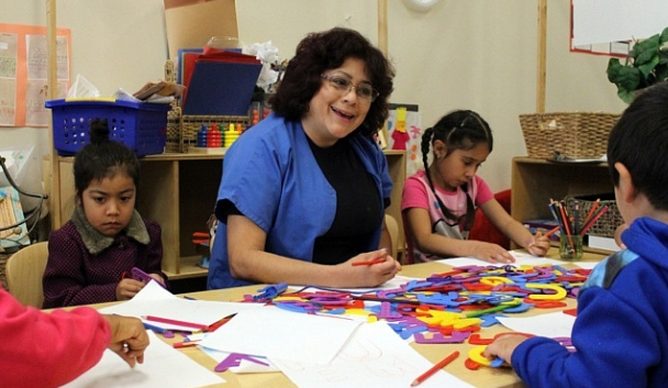 Children and teacher working with foam letters