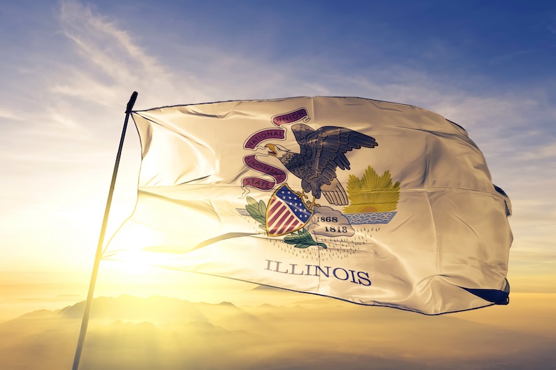 Illinois flag on pole waving in breeze