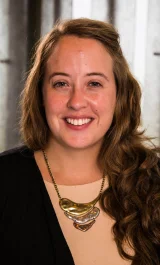 Headshot of Catherine Corr, University of Illinois professor and Co-PI of IECAM. She has long blond hair and is wearing a metallic medallion necklace. She is smiling.
