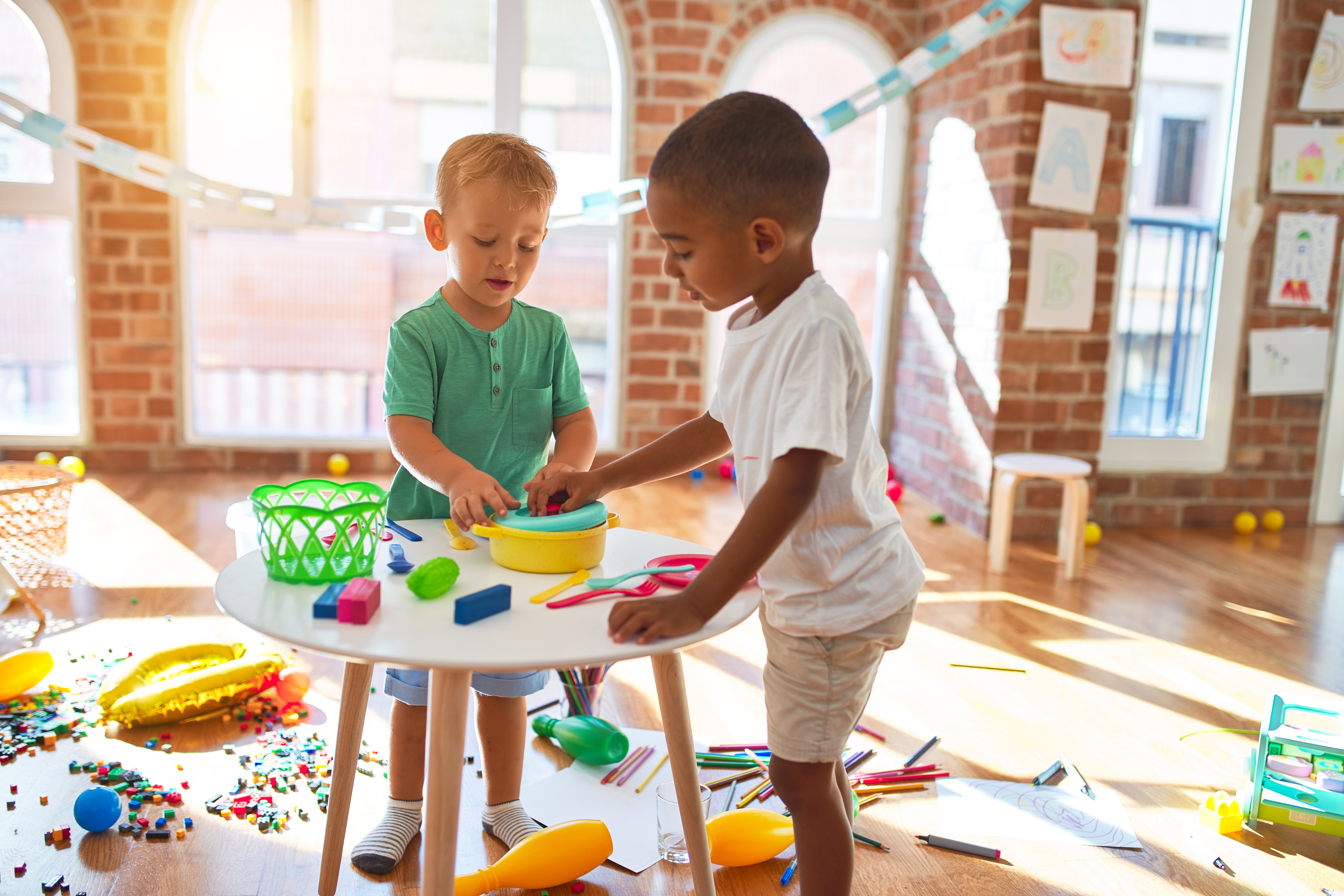 Two boys in child care playing with blocks on a table